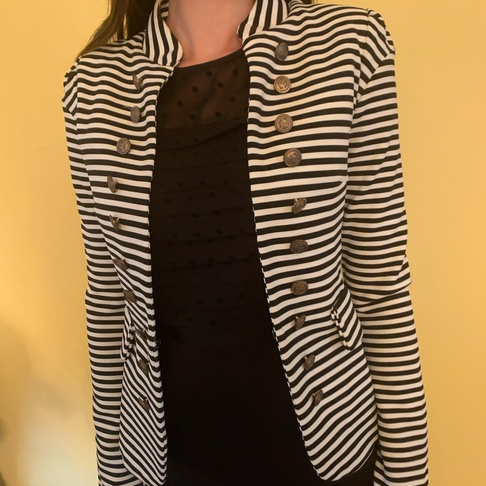 Black and white blazer, gold buttons.
